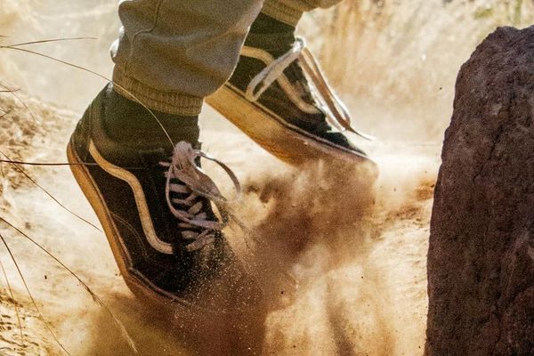Close-up of feet in running shoes on a natural trail.